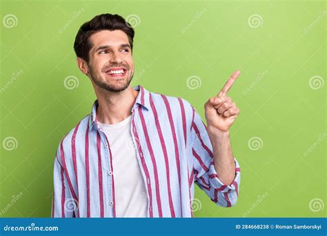 Photo Of Handsome Man With Stylish Haircut Dressed Striped Shirt Look Directing Empty Space