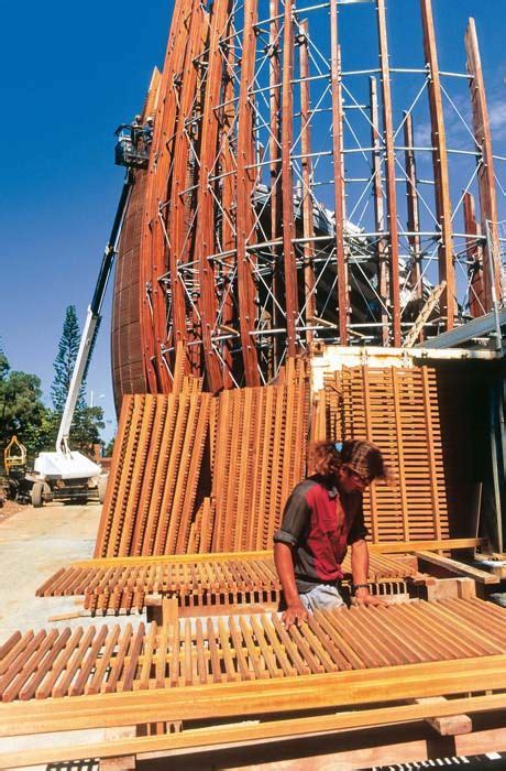 Two Men Are Working On Some Wooden Structures