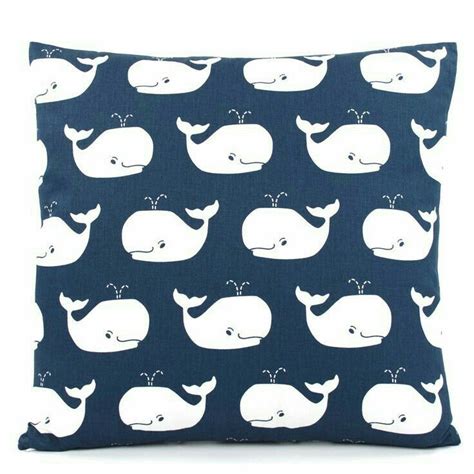 A Red Pillow With White Whales On It