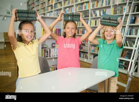 Happy Classmates Spending Time In The School Library Stock Photo Alamy