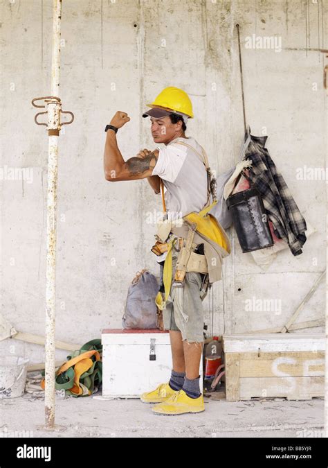 Hispanic Worker Flexing Biceps On Construction Site Stock Photo Alamy