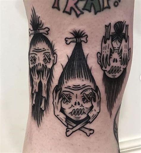 A Man With Tattoos On His Leg Has Three Skulls And A Clown S Head