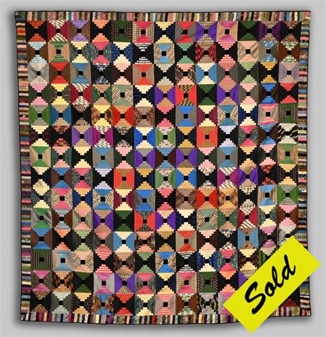 An Old Quilt With Many Different Colors And Patterns On The Front