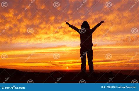 Silhouette Of Woman With Arms Raised At Sunset Stock Photo Image Of