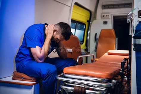 Paramedic Presses An Oxygen Mask To A Woman`s Face Who Is Lying On A