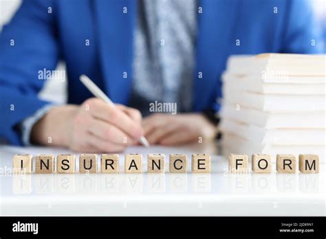 Man Filling Insurance Claim Form Word Collected Of Wooden Cubes Stock
