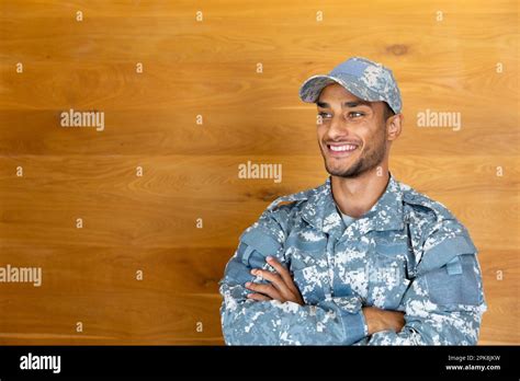 Happy Biracial Male Soldier Wearing Military Uniform Crossing Arms And