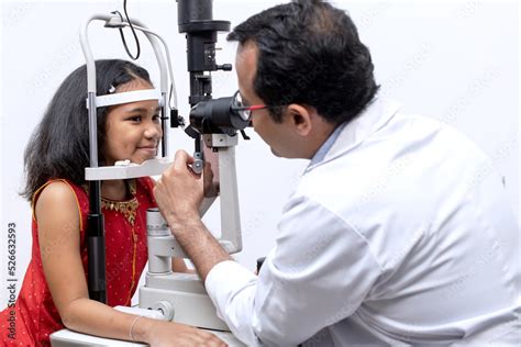 Indian Girl And Optometrist Doing Eye Test With Slit Lamp In Modern Ophthalmology Clinic