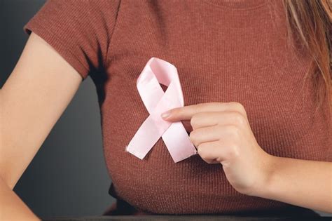 Premium Photo Woman Holding A Pink Ribbon At Her Chest