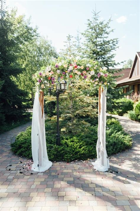 Arch For The Wedding Ceremony Decorated With Cloth And Flowers Stock