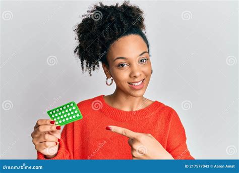 Young African American Girl Holding Birth Control Pills Smiling Happy