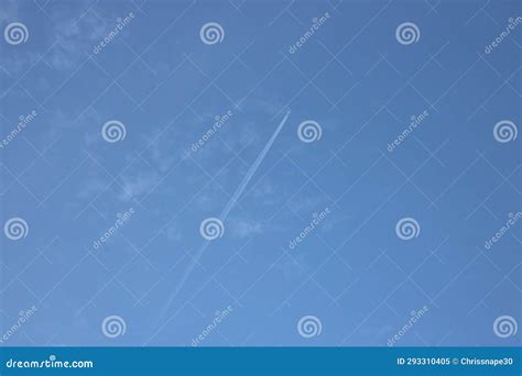 Aeroplane Flying High In Blue Sky With Jet Contrails Visible Stock