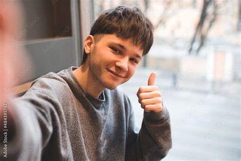 Smiling Gen Z Teenage Boy 17 18 Year Old Show Thumb Up To Camera And Make Selfie Closeup Happy