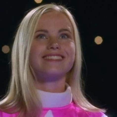 A Woman With Blonde Hair Wearing A Pink Outfit