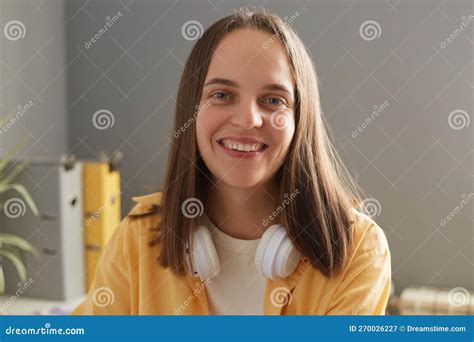 Portrait Of Beautiful Young Adult Woman Sitting In Office At Her Workplace Female With Brown