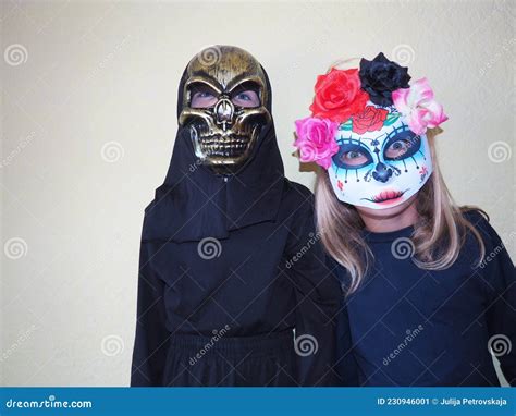 Children Dressed in Black Costumes and Scary Halloween Masks. Girl in a ...