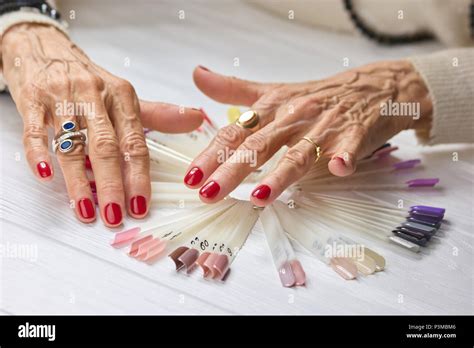 Wrinkled Woman Hands With Red Manicure Stock Photo Alamy