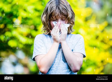 Boy Using Handkerchief While Sneezing Stock Photo Alamy