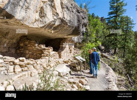 Tourists looking at some of the Sinagua cliff dwellings at Walnut Canyon National Monument, near ...