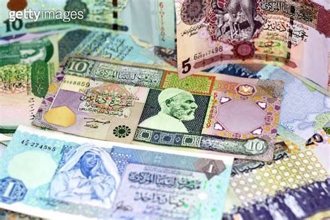 Background Of Libyan Money Dinars Banknotes With Portraits Of Omar Al