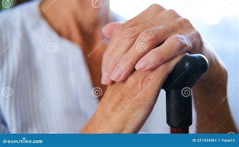 Caucasian Old Senior Grandmother Holding Walking Cane Stick In Hands