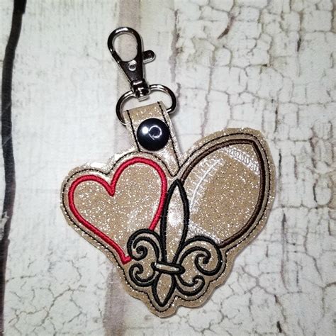 Fleur De Lis Football Snap Tab Embroidery Designs Football In The Hoop Key Fob Embroidery