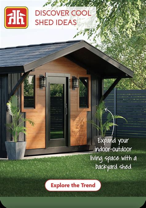 A Small Wooden Shed Sitting On Top Of A Lush Green Field