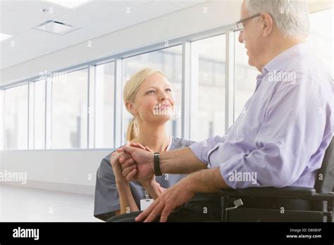 Caucasian nurse talking to patient in hospital Stock Photo - Alamy