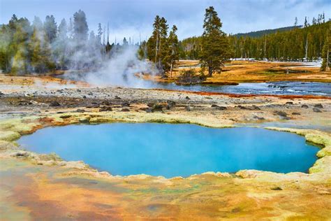 Beautiful Deep Blue Yellowstone Pools Of Alkaline Water In Basin Stock