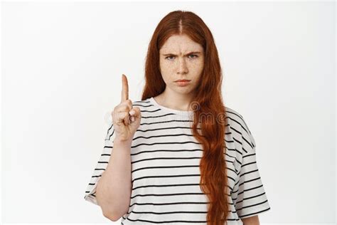 Angry And Displeased Redhead Girl Pointing Finger Up Judgemental Frowning With Dislike