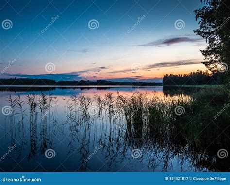 Sunset On The Shores Of The Calm Saimaa Lake In The Linnansaari