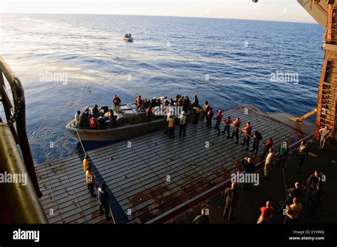 Us Navy Sailors Transfer Refugees Rescued From Sinking Boats To The