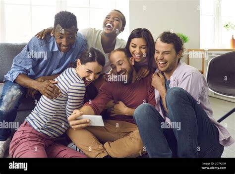 Cheerful Multiracial Friends Have Fun And Take Selfies During Friendly