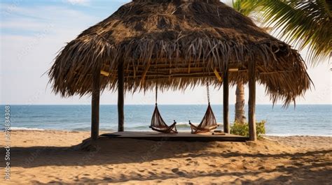 Man Sitting On Swing Under Thatched Roof Hut At Beach Cartagena De