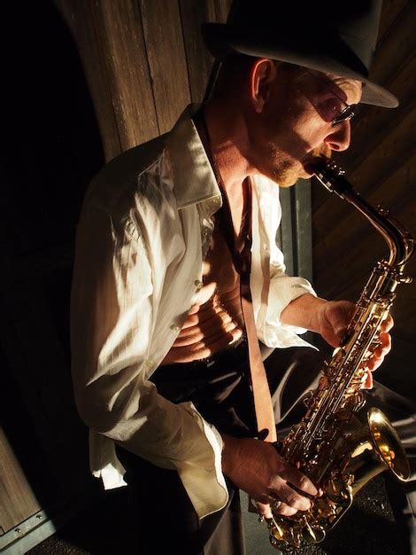 Premium Photo High Angle View Of Mature Man Playing Saxophone