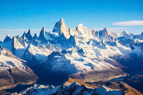 Premium Photo A Dramatic Mountain Range With Snow Capped Peaks