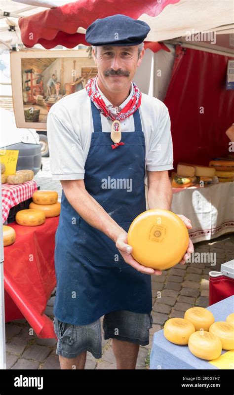 Cheese Vendor Holding A Wheel Of Gouda Cheese At The Gouda Cheese