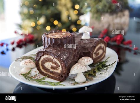 Decorated yule log with christmas tree in the background Stock Photo ...