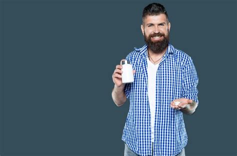 Premium Photo Cheerful Mature Man Hold Medication Pill On Grey Background