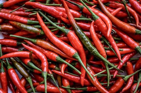 Premium Photo Pile Of Red Hot Chillies Background And Pattern