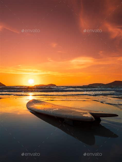 Surfboard On The Beach In Sea Shore At Sunset Time Stock Photo By Netfalls