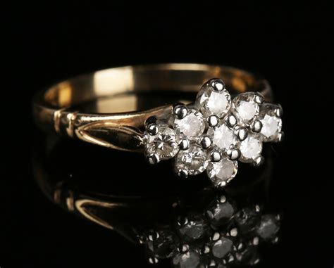 A 9ct Gold And Diamond Nine Stone Cluster Ring Mounted With Circular