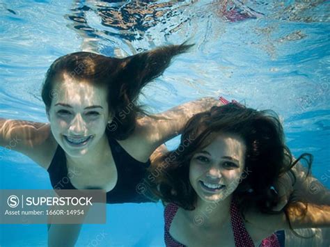 Girls Swimming Underwater In Pool Superstock