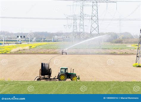 Tractor With Irrigation Equipment Watering Crops Editorial Photo