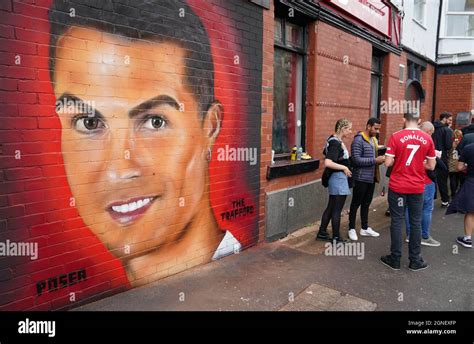 Manchester United Fans Near A Mural Of Cristiano Ronaldo Before The