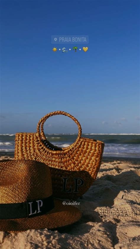 Two Straw Bags Sitting On Top Of A Sandy Beach Next To The Ocean And