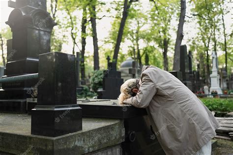 Premium Photo Man Crying Over A Grave At The Cemetery