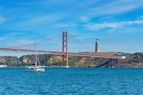 Premium Photo View Of De Abril Bridge Over Tagus River Christ The