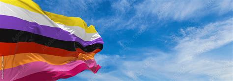 Nonbinary Lesbian Flag Waving In The Wind At Cloudy Sky Freedom And