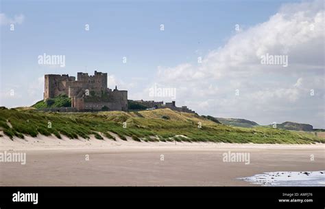 Landscape Shot Of Bamburgh Castle As Taken From The Beach Showing Sand